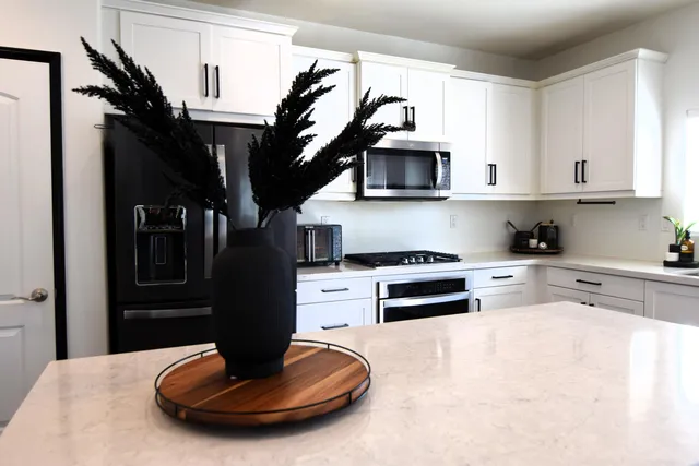 a living room with a couch and a potted plant