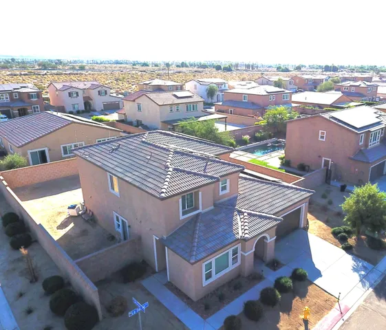 an aerial view of residential houses with outdoor space and ocean view