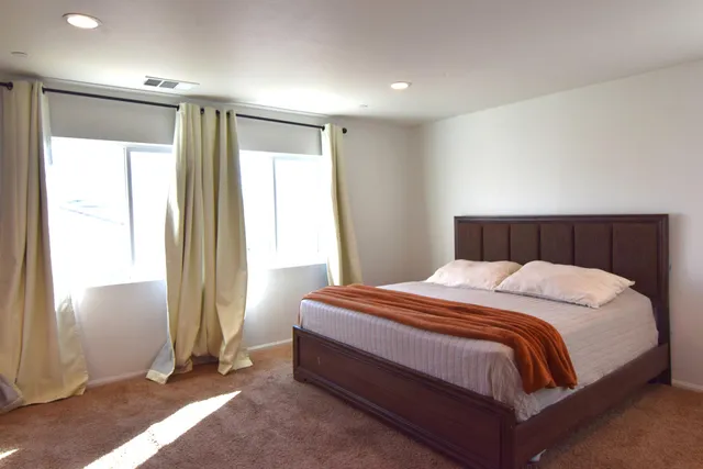 a view of a house with wooden fence