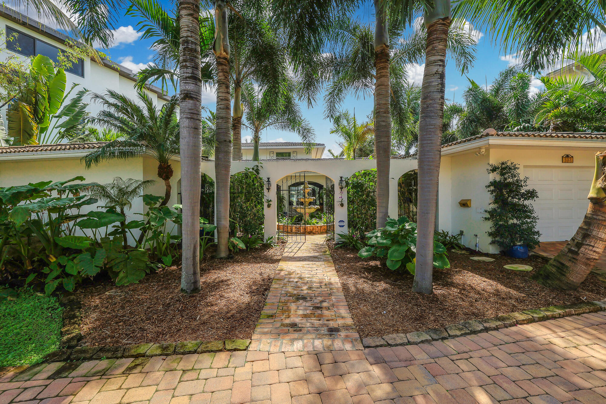 2560 Southeast 7th Drive Pompano Beach, FL 33062 - Photo 2 of 74 a view of entrance gate of the house and lake view