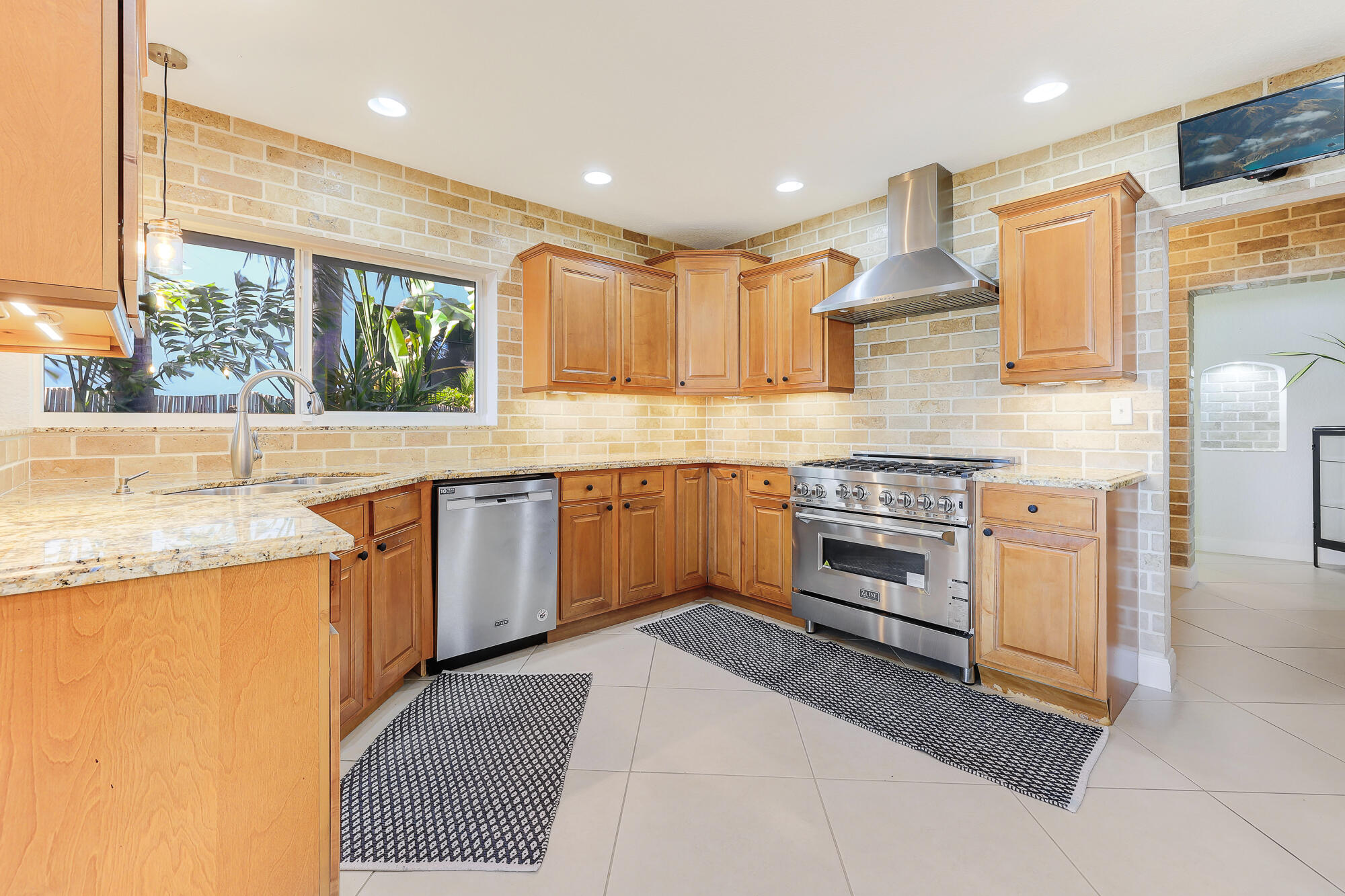 2560 Southeast 7th Drive Pompano Beach, FL 33062 - Photo 21 of 74 a kitchen with stainless steel appliances granite countertop a stove a sink and a refrigerator