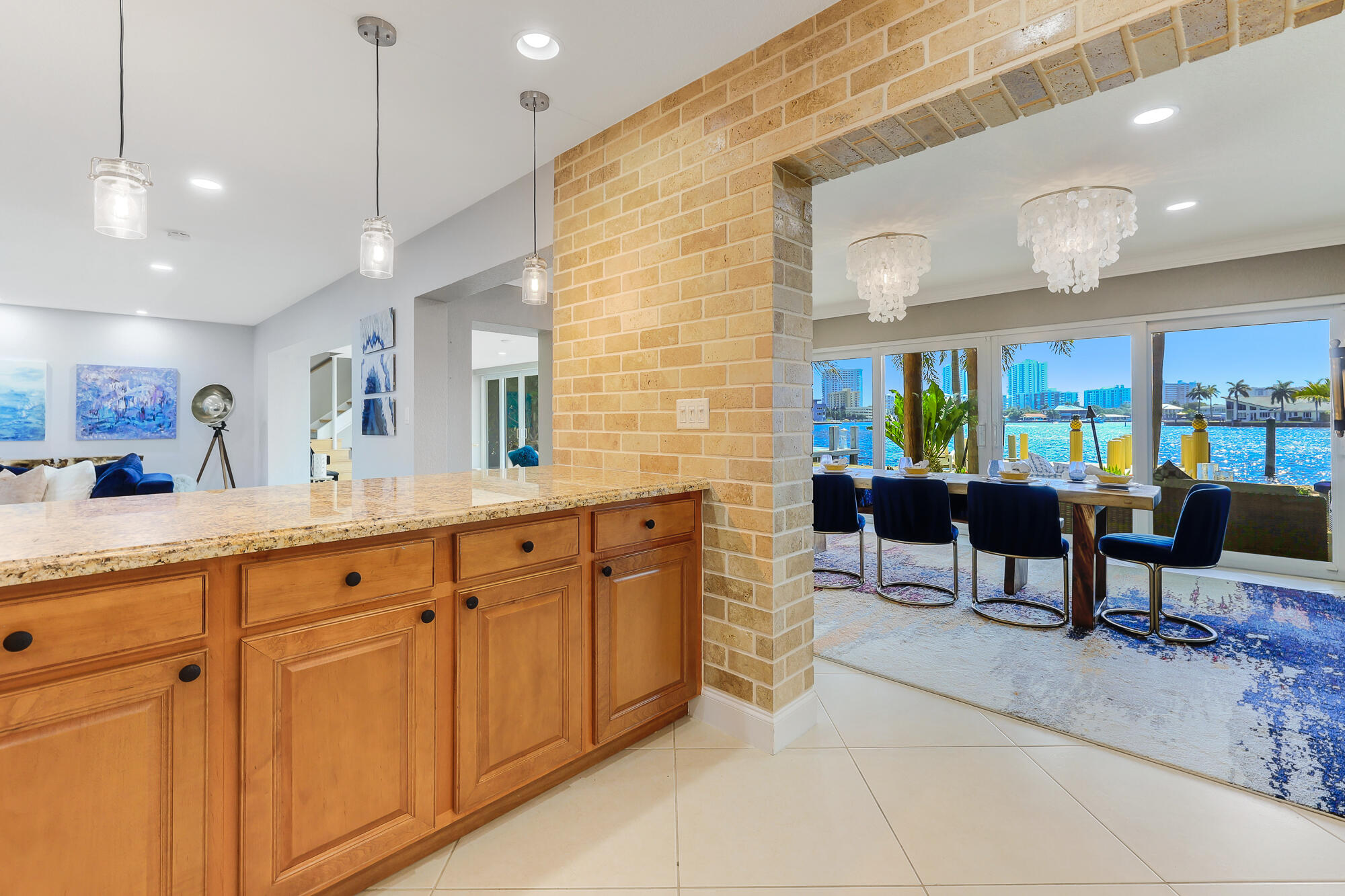 2560 Southeast 7th Drive Pompano Beach, FL 33062 - Photo 23 of 74 a kitchen with stainless steel appliances kitchen island granite countertop a table and chairs in it