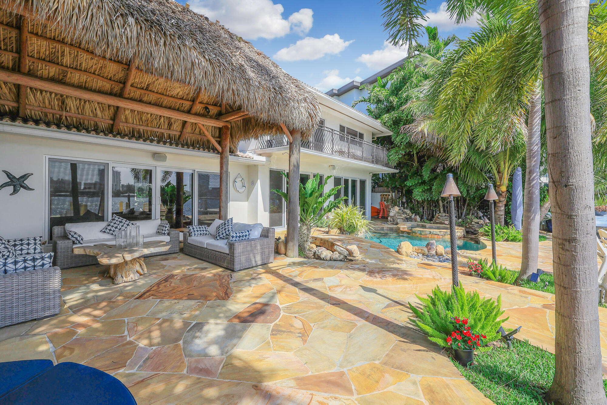 2560 Southeast 7th Drive Pompano Beach, FL 33062 - Photo 46 of 74 a view of a patio with a table and chairs under an umbrella
