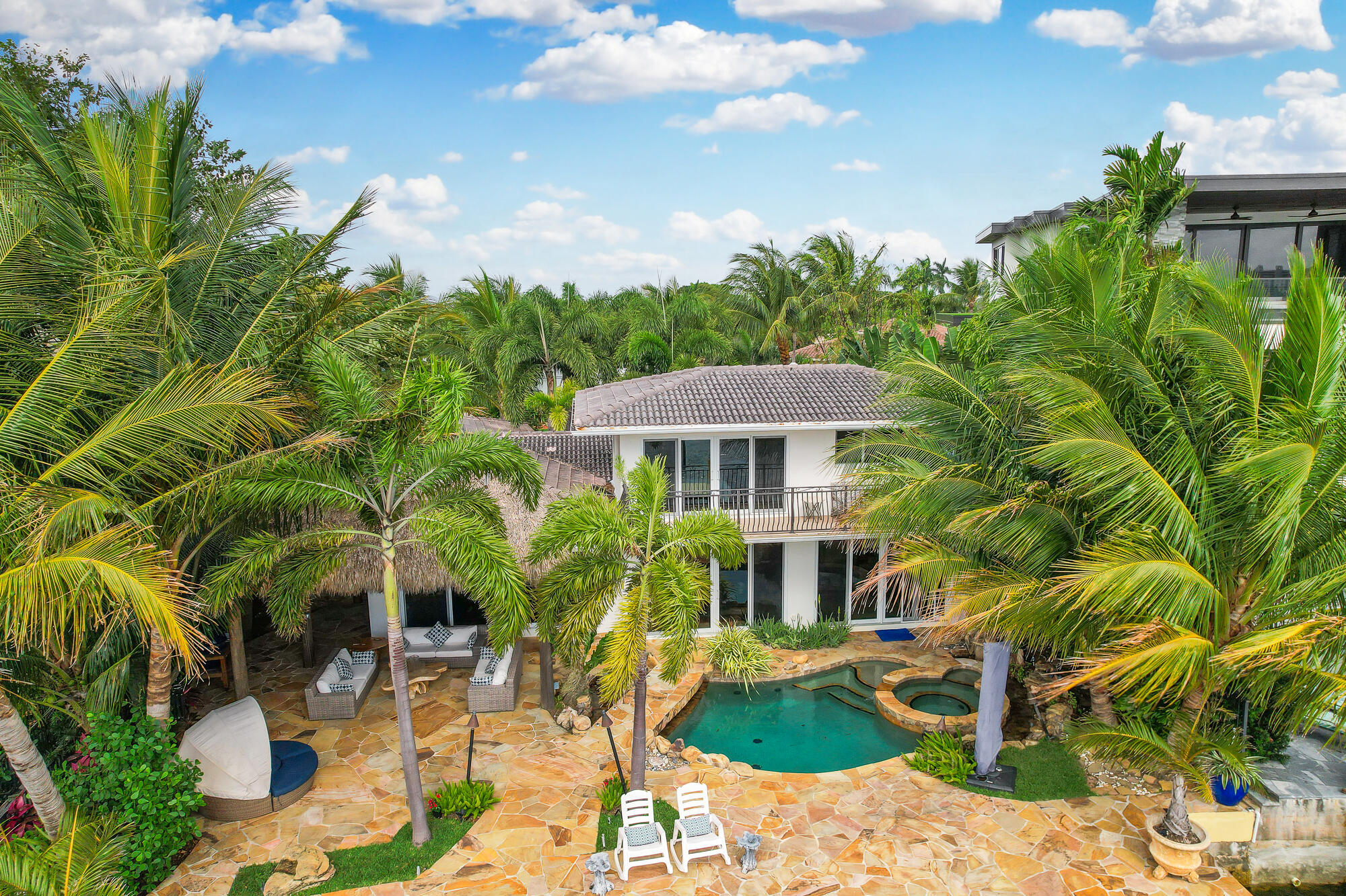 2560 Southeast 7th Drive Pompano Beach, FL 33062 - Photo 72 of 74 a front view of a house with yard porch and furniture