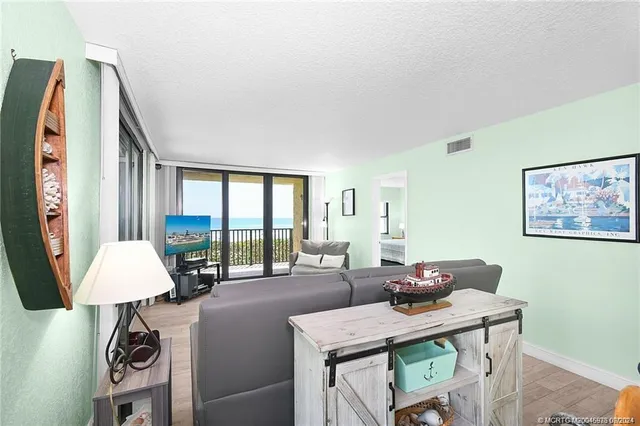 a view of a livingroom with furniture and a large window