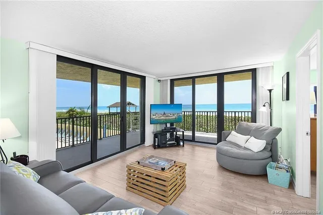 a living room with furniture and a floor to ceiling window