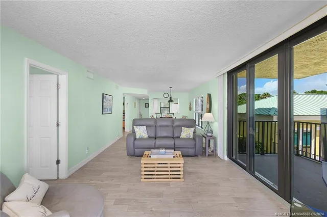 a living room with furniture and a floor to ceiling window