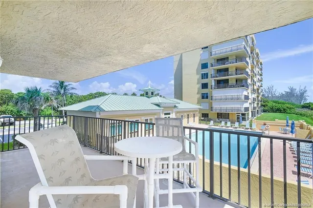 a view of a patio with a table and chairs