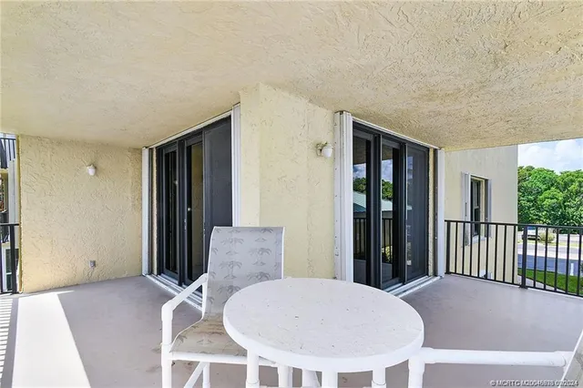 a view of a bedroom with furniture and windows