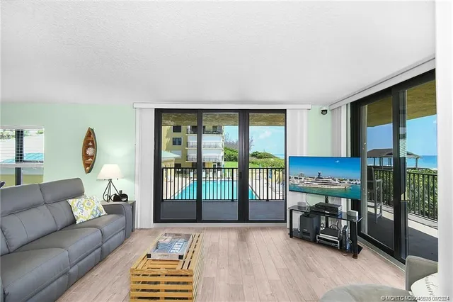 a living room with furniture and a floor to ceiling window