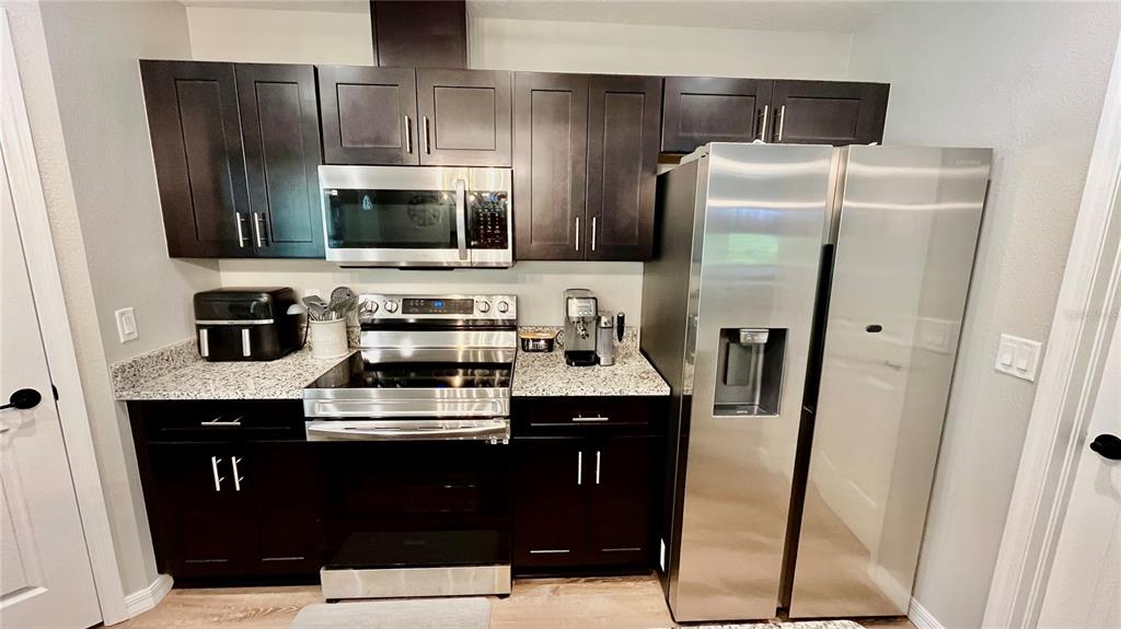 13486 English Sparrow Road Weeki Wachee, FL 34614 - Photo 10 of 51 a kitchen with a sink a refrigerator and cabinets