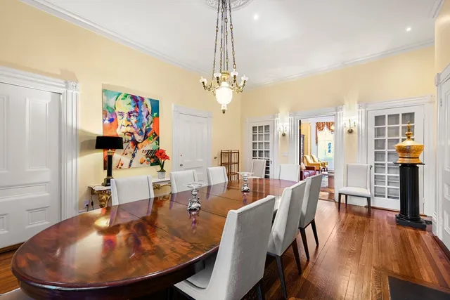 a view of a dining room with furniture wooden floor and chandelier