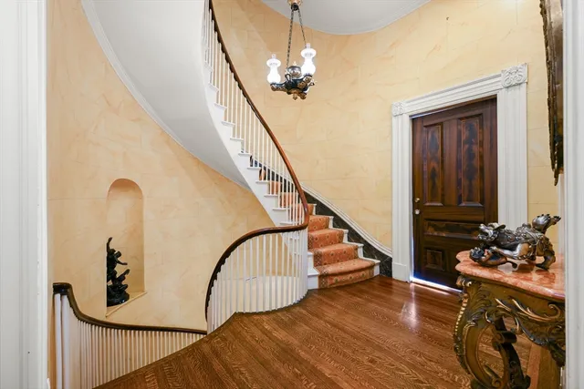 a view of entryway and hall with wooden floor