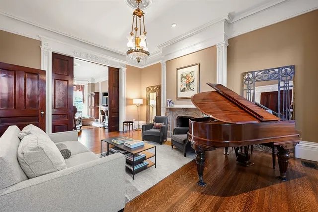 a living room with furniture a dining table and a chandelier