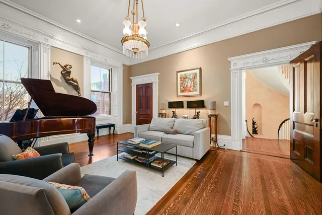 a living room with furniture or couch and a chandelier