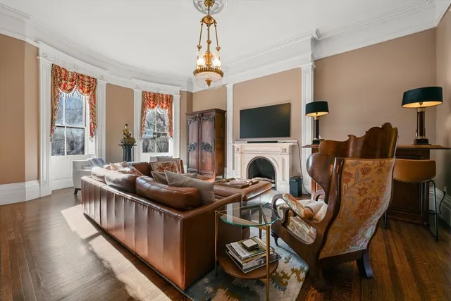 a living room with furniture a fireplace and a flat screen tv