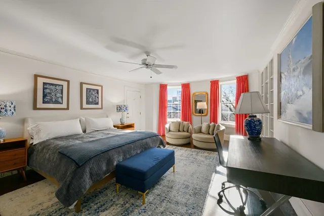 a bedroom with a large bed and a couch