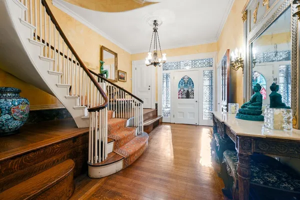 a view of entryway and hall with wooden floor