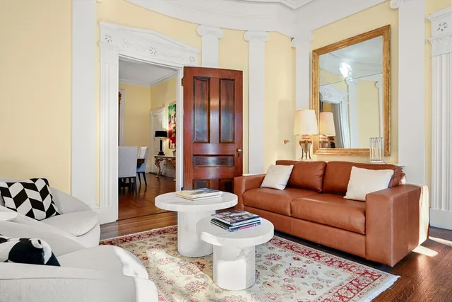 a living room with furniture and a toilet