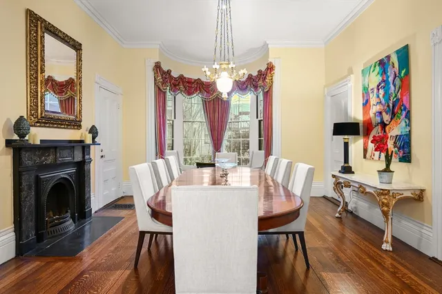 a view of a dining room with furniture a chandelier and wooden floor