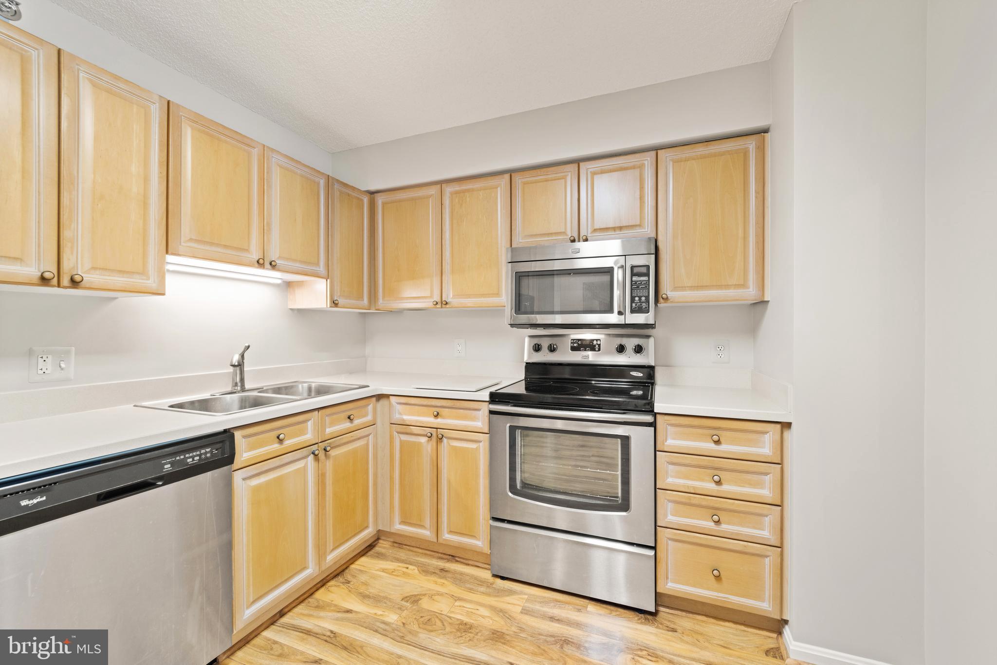 a kitchen with a sink stove and microwave