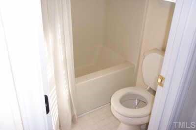 2339 Turtle Point Drive Raleigh, NC 27604 - Photo 6 of 7 a white toilet sitting next to a bath tub