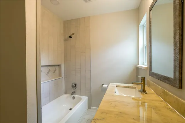 a bathroom with a tub and shower