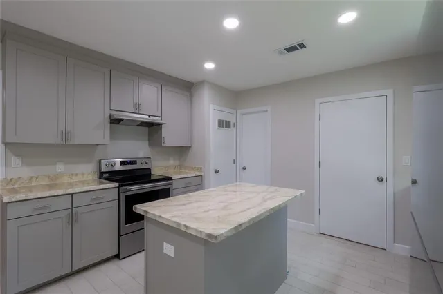 a kitchen that has a sink and a stove in it