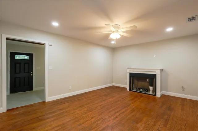 an empty room with closet and a fireplace