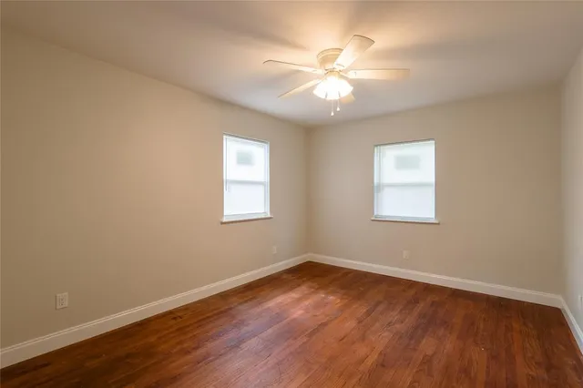 a view of a room with wooden floor and windows