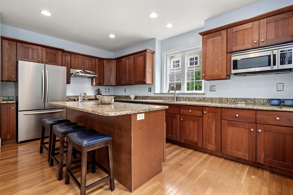 8 Maple Leaf Drive Boston, MA 02136 - Photo 7 of 29 a kitchen with granite countertop wooden cabinets a refrigerator a stove a sink and a oven