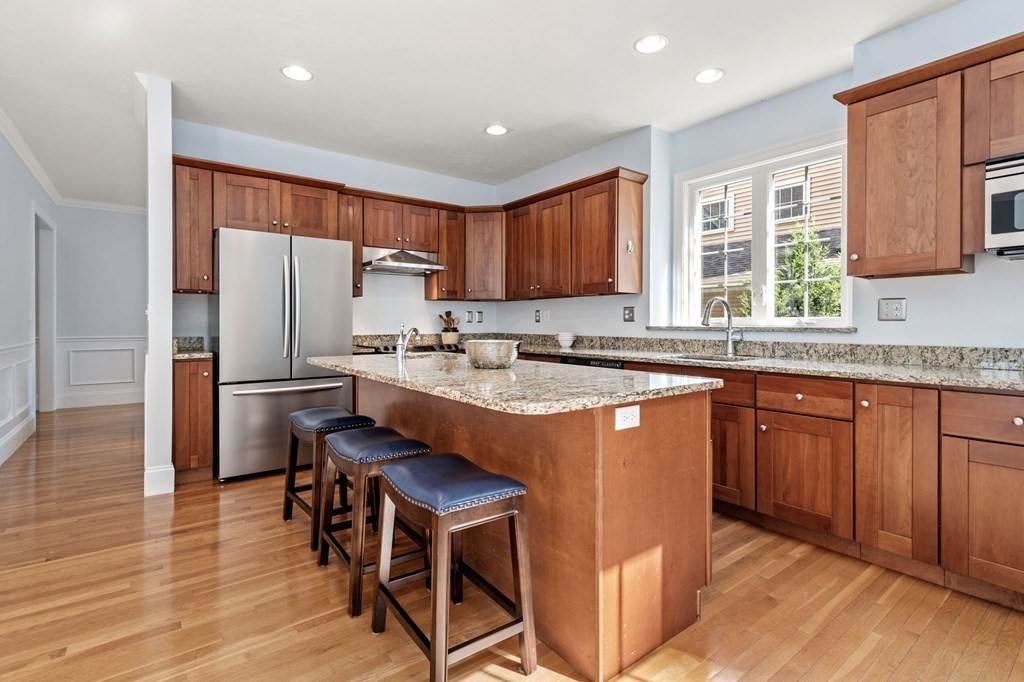 8 Maple Leaf Drive Boston, MA 02136 - Photo 9 of 29 a kitchen with stainless steel appliances granite countertop a refrigerator a sink dishwasher a stove and white countertops with wooden floor