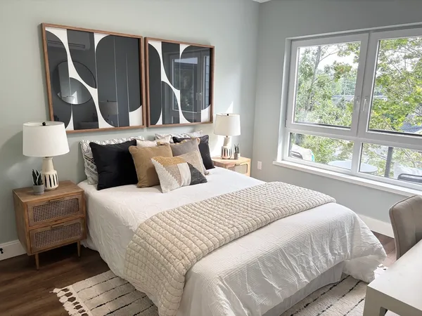 a bedroom with a bed and wooden floor