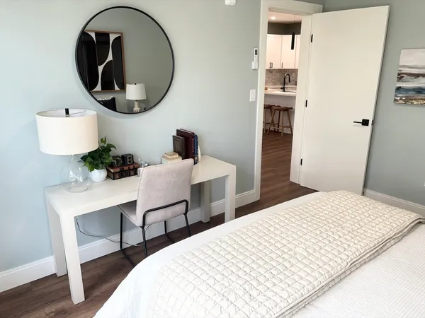 a bedroom with a bed and a potted plant