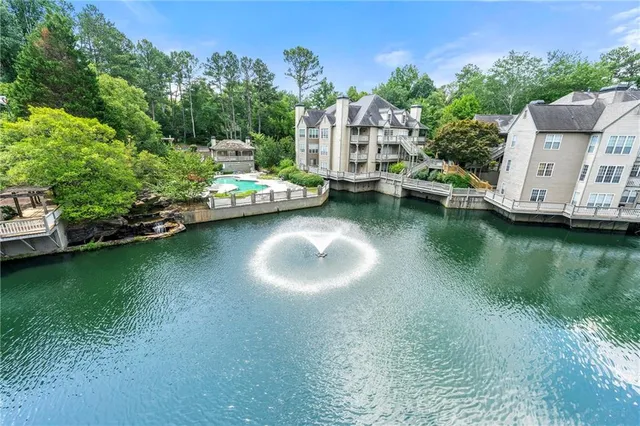 an aerial view of a house with a garden and houses