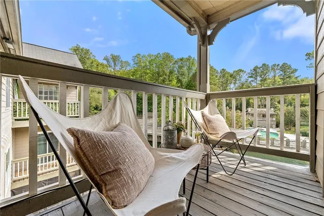 a view of balcony with wooden floor and outdoor seating