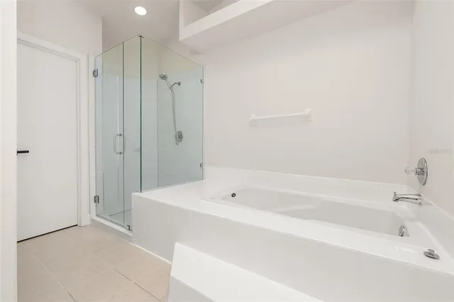 a spacious bathroom with a bathtub and shower