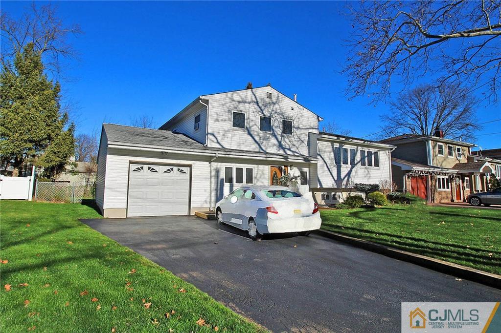 54 Starlight Drive Colonia, NJ 07067 - Photo 2 of 25 a front view of a house with a garden