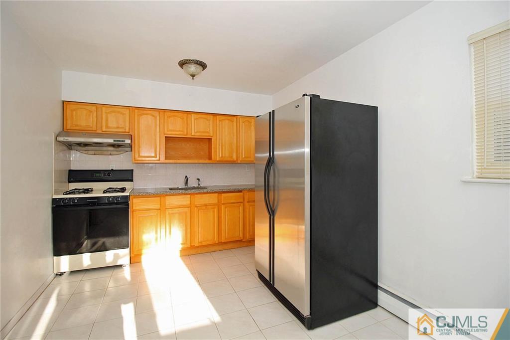 54 Starlight Drive Colonia, NJ 07067 - Photo 11 of 25 a kitchen with stainless steel appliances granite countertop a refrigerator and a sink
