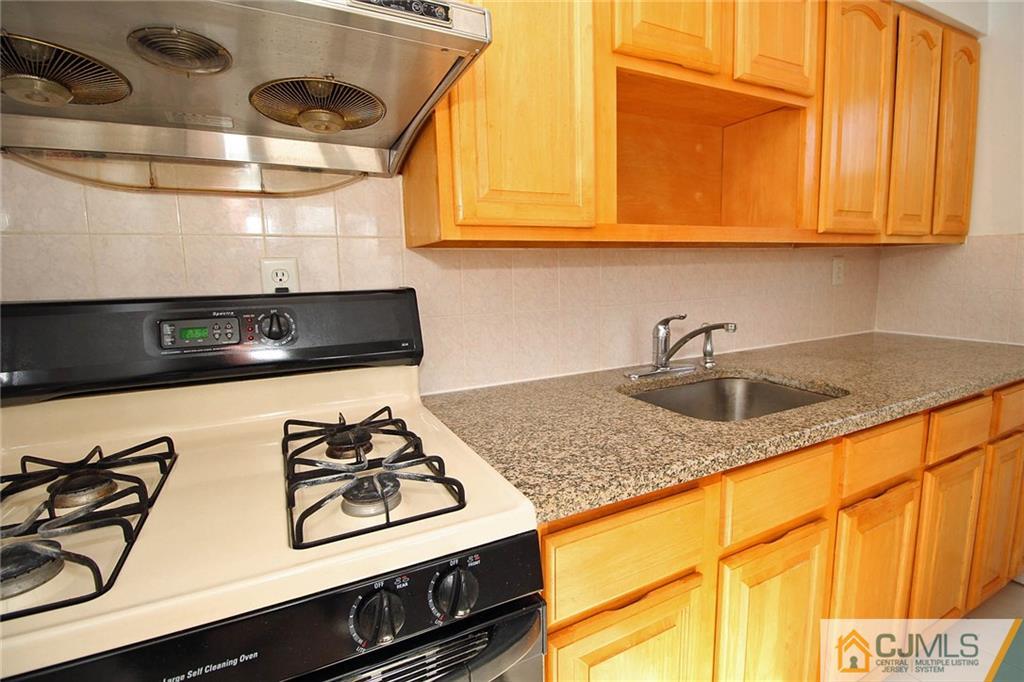 54 Starlight Drive Colonia, NJ 07067 - Photo 12 of 25 a kitchen with stainless steel appliances granite countertop a sink and a stove