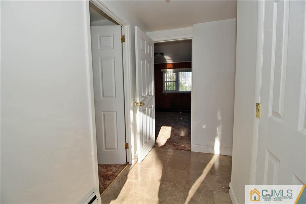 54 Starlight Drive Colonia, NJ 07067 - Photo 14 of 25 a view of a hallway with a livingroom and a bathroom with sink