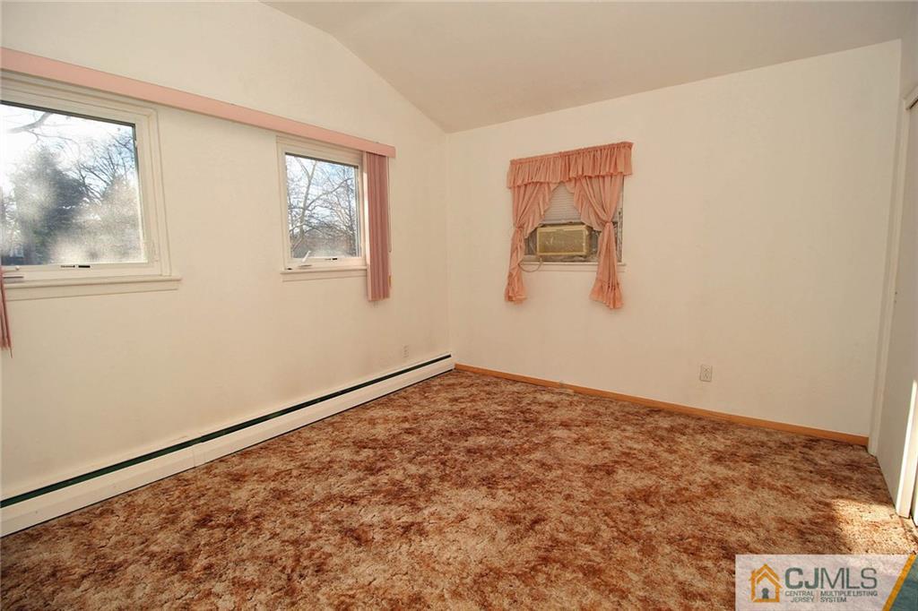 54 Starlight Drive Colonia, NJ 07067 - Photo 18 of 25 a view of an empty room with wooden floor and a window