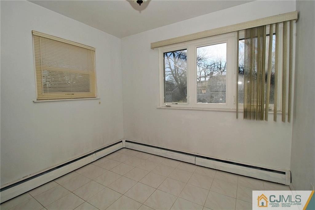 54 Starlight Drive Colonia, NJ 07067 - Photo 21 of 25 a view of empty room with window and hardwood floor