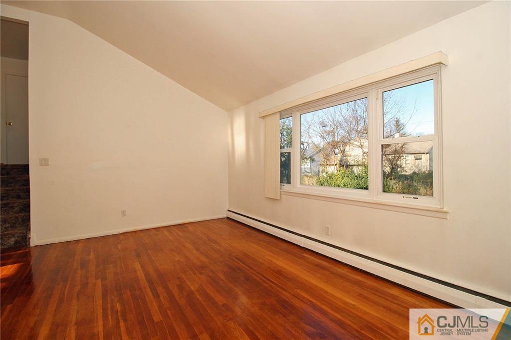 54 Starlight Drive Colonia, NJ 07067 - Photo 6 of 25 an empty room with wooden floor and windows