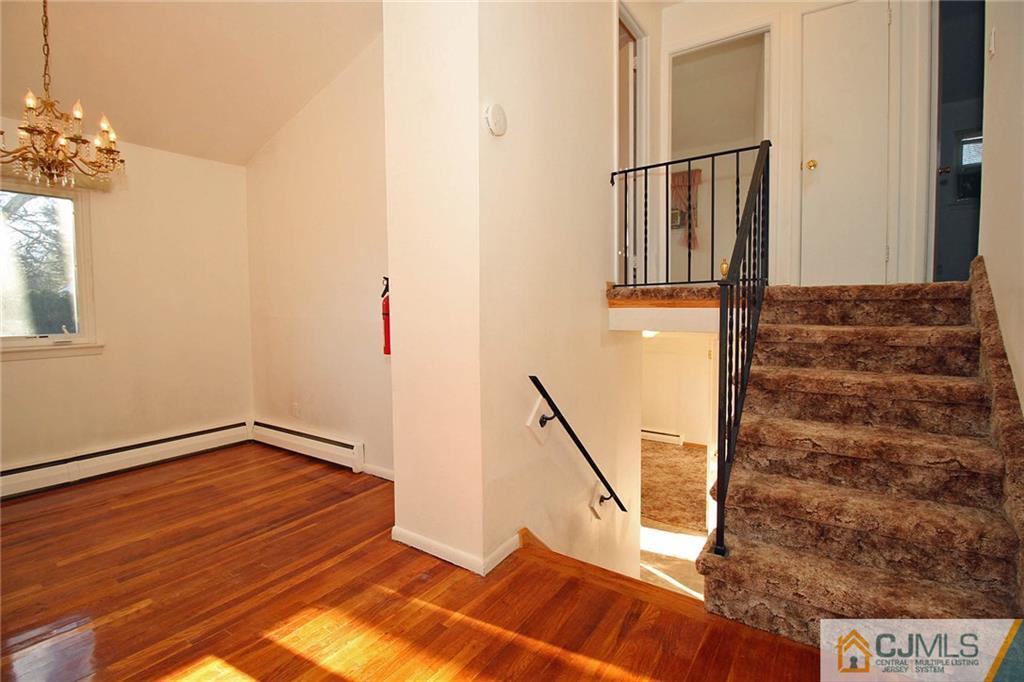 54 Starlight Drive Colonia, NJ 07067 - Photo 8 of 25 a view of entryway and hall with wooden floor