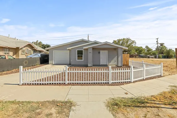 a view of a house with wooden fence