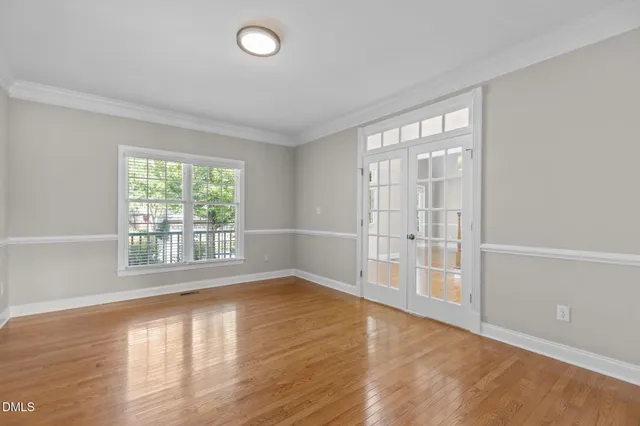 a view of a kitchen with stainless steel appliances granite countertop a refrigerator and a stove top oven