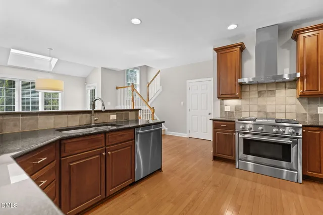 a kitchen with lots of counter space and windows
