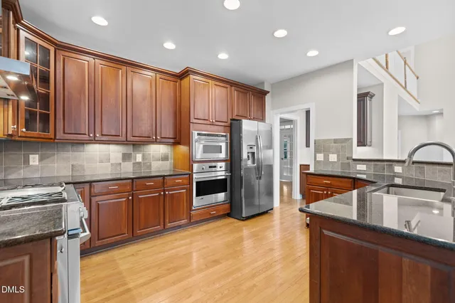 a view of a kitchen with wooden floor and a window