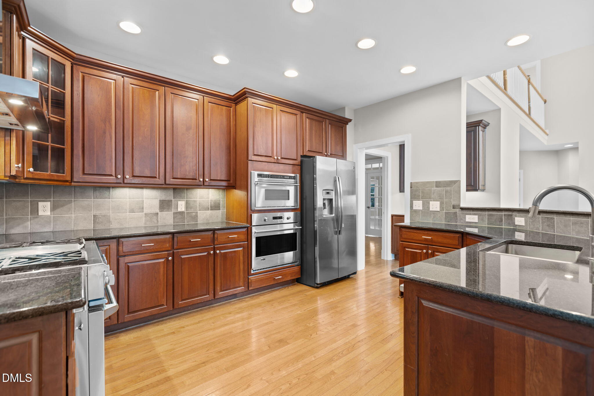 11552 Auldbury Way Raleigh, NC 27617 - Photo 17 of 62 a kitchen with stainless steel appliances granite countertop a sink stove and refrigerator